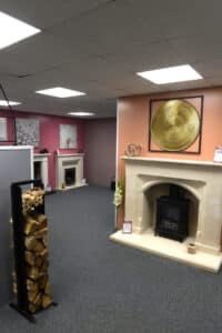 Wessex English Bathstone fireplace with Gazco Sheraton electric stove at Zigi_s Cambridge (vertical)